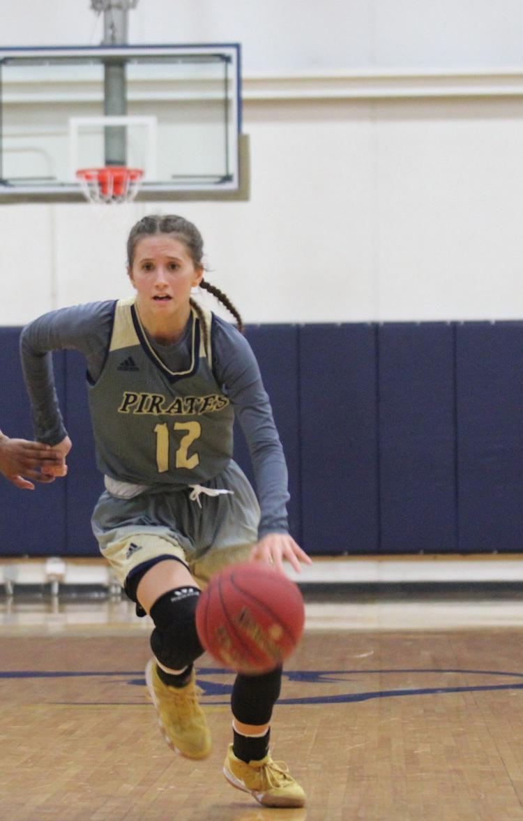 Logan Collyer (12) dribbles the ball up the court. Photo Credit: Nick Dailey